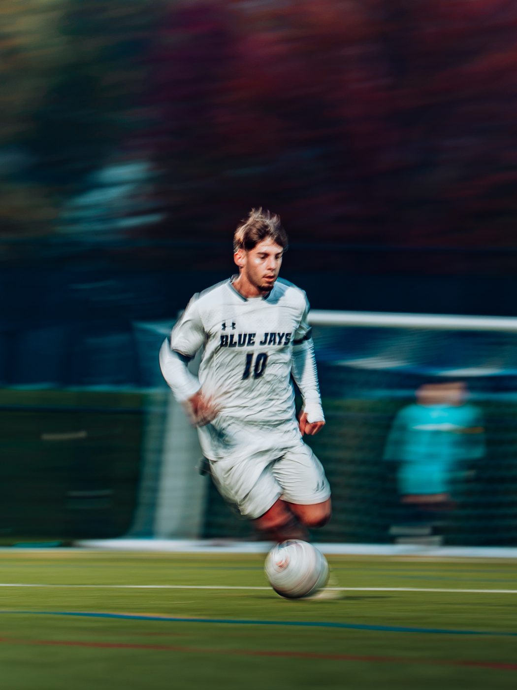 A soccer player dribbling, original